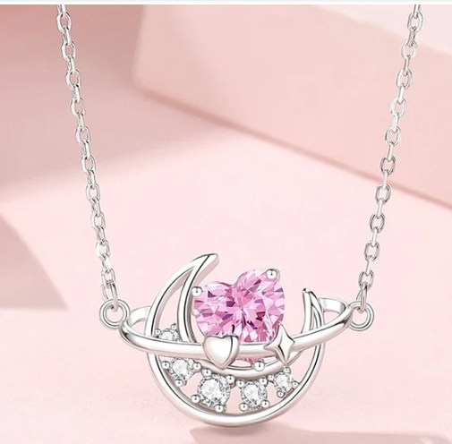 Collar con luna y corazón rosa en plata de ley sobre fondo rosa